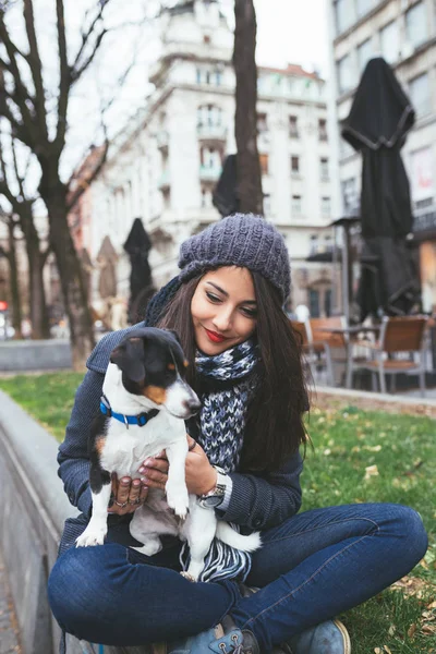 fashionable  young girl with dog on the street