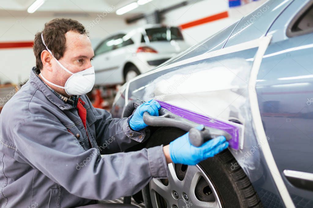 Car detailing - Man preparing car for painting procedure