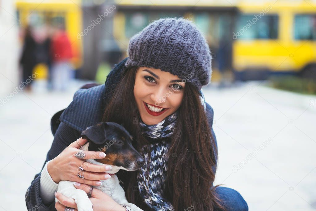 fashionable  young girl with dog on the street