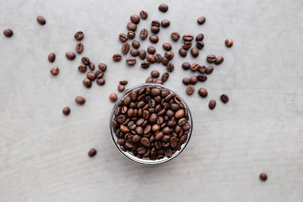 Close up shot of roasted coffee beans in a cup.