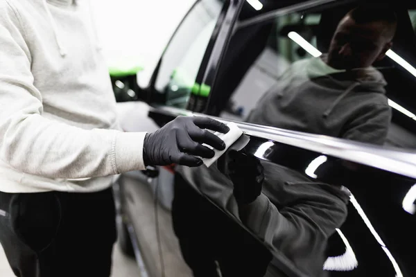 Professional cleaner and car cleaning concept. Unrecognizable man cleans  car interior with cloth. Selective focus. Washing auto dashboard with rag  7907126 Stock Photo at Vecteezy
