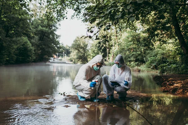 Two Scientists Protective Suits Taking Water Samples River — Stock Photo, Image