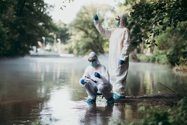 Two Scientists Protective Suits Taking Water Samples River — Stock Photo, Image