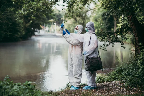 Two Scientists Protective Suits Taking Water Samples River — Stock Photo, Image