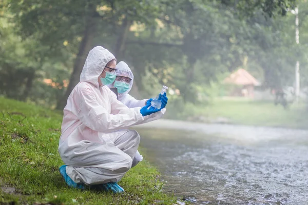 Two Scientists Protective Suits Taking Water Samples River — Stock Photo, Image