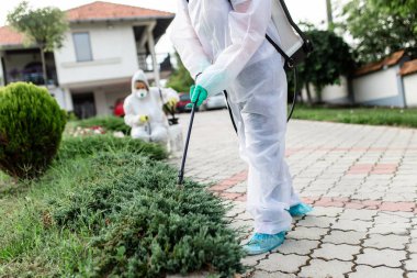 İş yerinde yok ediciler püskürtücü ile pestisit püskürtme giymek.