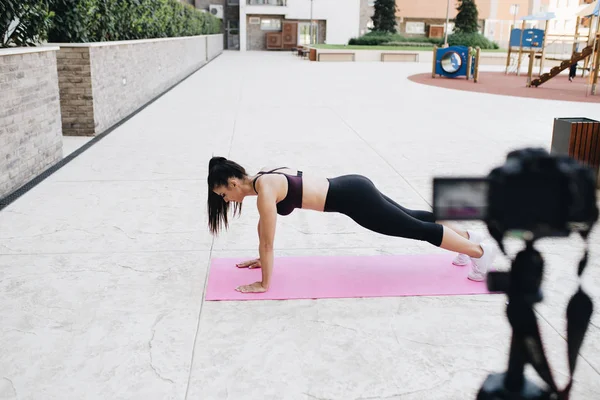 Young female vlogger recording content for her video blog. Fitness and healthy lifestyle concept.