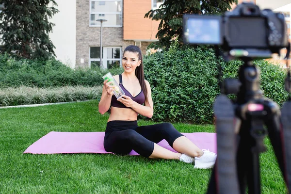 Young female vlogger recording content for her video blog. Fitness and healthy lifestyle concept.