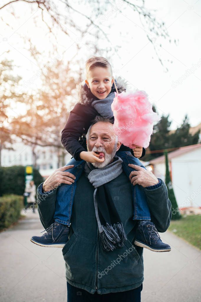 Grandfather with his grandson enjoying in walk. 