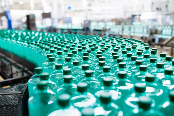 Bottling plant - Water bottling line for processing and bottling pure spring water into bottles. Selective focus.