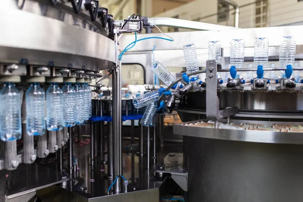 Bottling plant - Water bottling line for processing and bottling carbonated water into bottles. Selective focus.