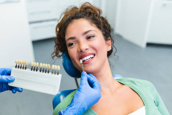 Beautiful young woman having dental treatment at dentist's office. 