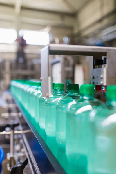 Bottling plant - Water bottling line for processing and bottling pure spring water into bottles. Selective focus.