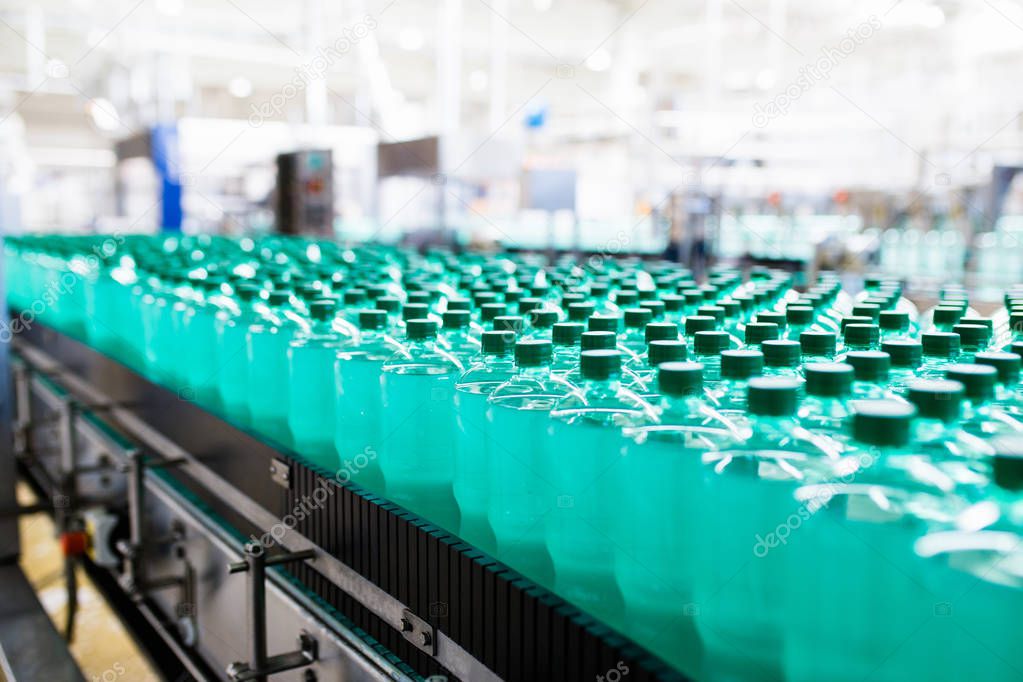 Bottling plant - Water bottling line for processing and bottling pure spring water into bottles. Selective focus. 