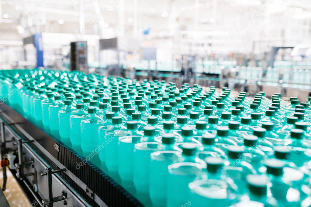 Bottling plant - Water bottling line for processing and bottling carbonated water into bottles. Selective focus. 