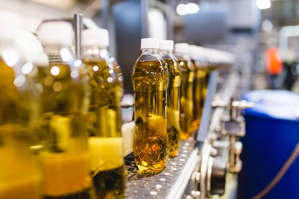 Bottling factory - Apple juice bottling line for processing and bottling juice into bottles. Selective focus.