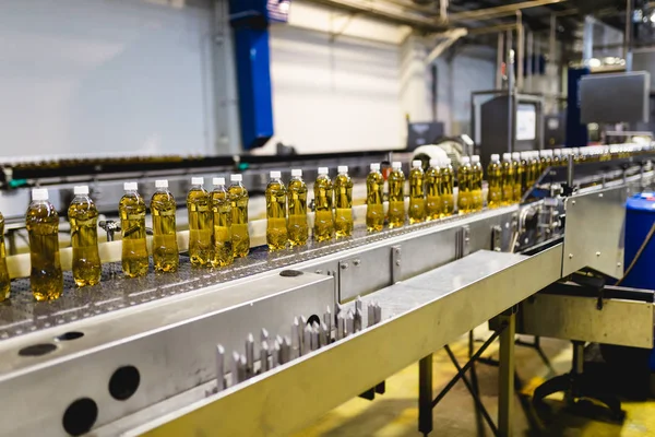 Bottling factory - Apple juice bottling line for processing and bottling juice into bottles. Selective focus.