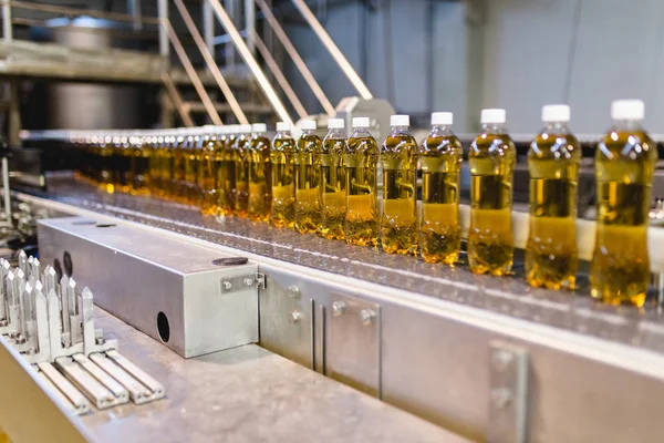 Bottling factory - Apple juice bottling line for processing and bottling juice into bottles. Selective focus.