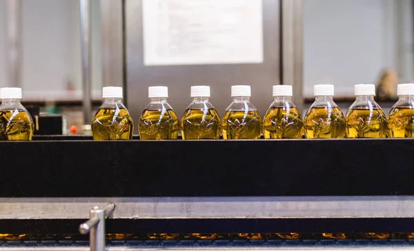 Bottling factory - Apple juice bottling line for processing and bottling juice into bottles. Selective focus.