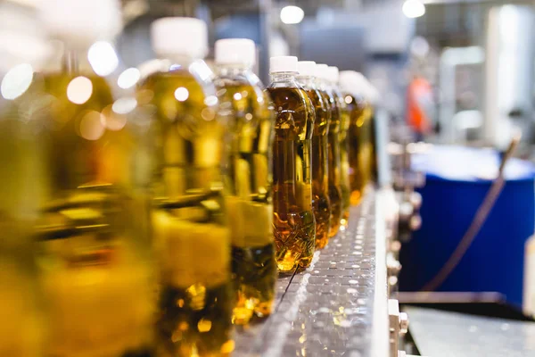 Bottling factory - Apple juice bottling line for processing and bottling juice into bottles. Selective focus.