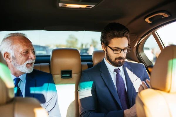 Senior Affärsman Och Hans Assistent Sitter Limousine Och Arbetar — Stockfoto