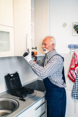 Mutfakta çalışan usta bir tamirci. Yenileme.