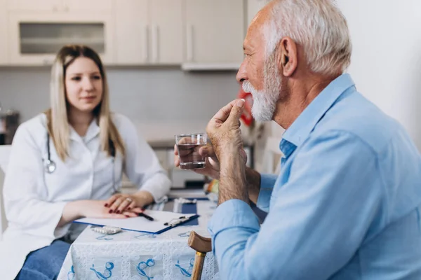 Young Positive Caregiver Taking Care Senior Man Nursing Home — Stock Photo, Image