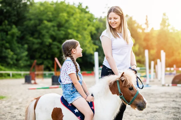 Cute Little Girl Her Older Sister Enjoying Pony Horse Outdoors Stock Image