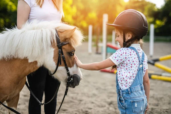 Cute Little Girl Her Older Sister Enjoying Pony Horse Outdoors Royalty Free Stock Images