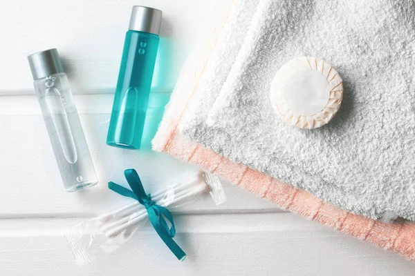 Personal care products for body care on the table - shower gel and shampoo with towels.