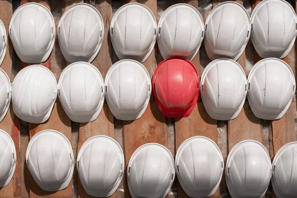 Safety helmets hanging on a wooden shield — Stockfoto