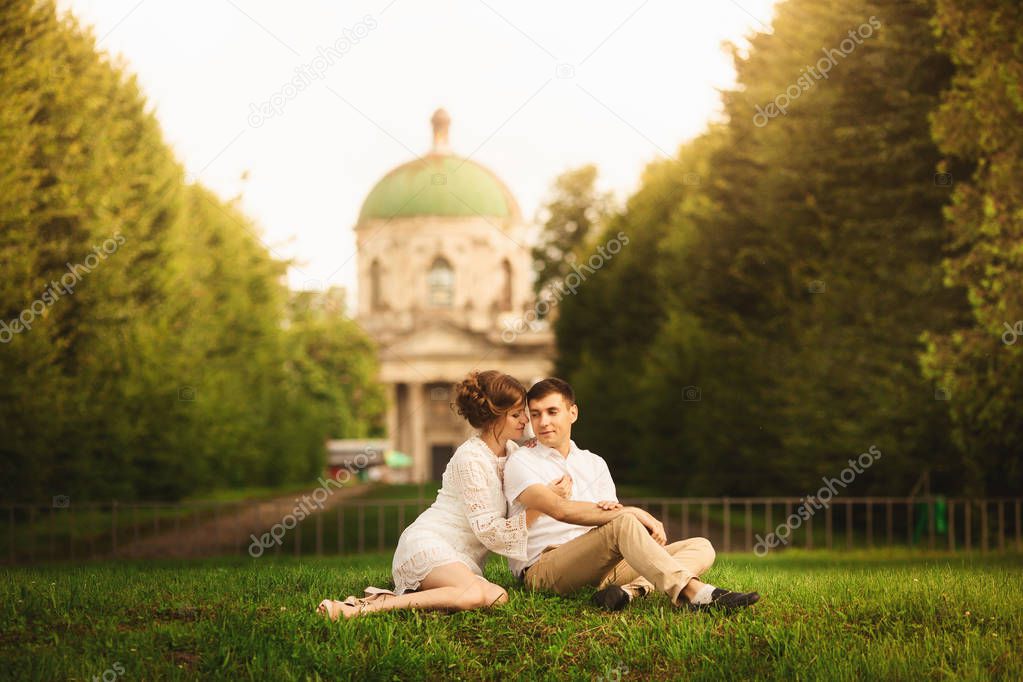 Charming and fashionable couple in love background old vintage castle