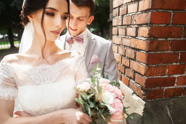 Increíble pareja de boda. Novia bonita y elegante novio cerca de la iglesia —  Fotos de Stock