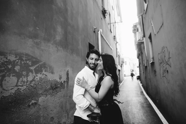 Loving couple gently leaning against each other in the old city. Black and white