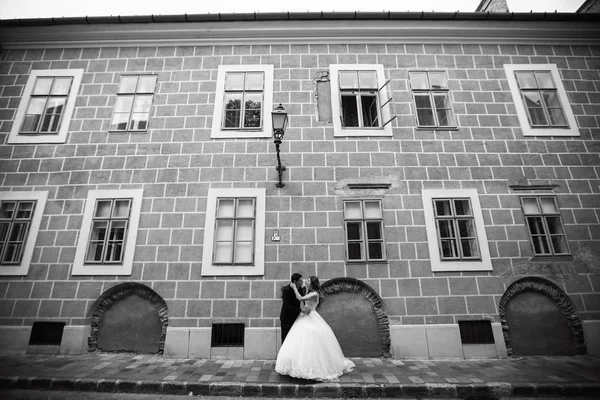 Pár objetí na ulici, na pozadí staré budovy. Budapešť. Černobílá — Stock fotografie