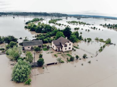 Flooded yard near the Dniester River. Flood on the river. Natural disaster in Western Ukraine. clipart