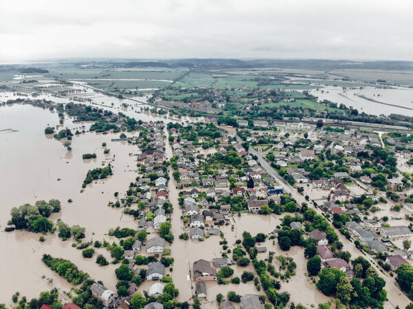 Aerial view of the heavily flooded village on Western Ukraine. The flood on the Dniester River caused a natural disaster. Streets, roads, parks and houses in dirty rainwater.