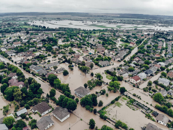 Flooded village on Ukraine. Natural disaster in village Halych, courtyards and streets in dirty water. Global catastrophe, climate change, flood concept.