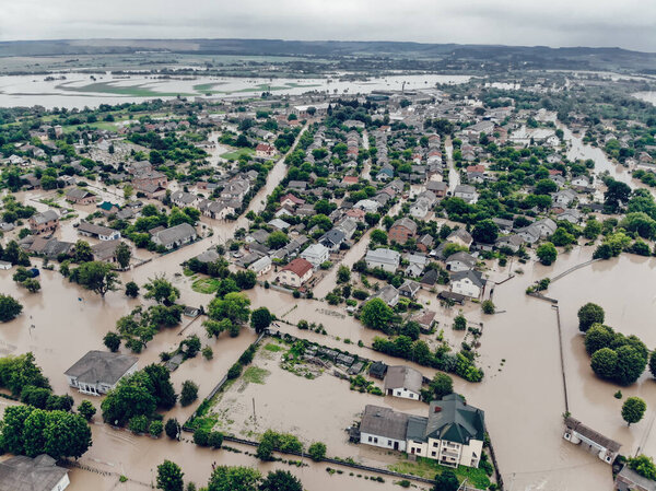 Flooded village on Ukraine. Natural disaster in village Halych, courtyards and streets in dirty water. Global catastrophe, climate change, flood concept.
