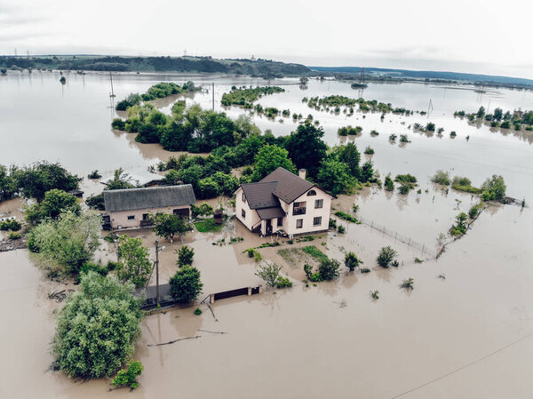 Flooded yard near the Dniester River. Flood on the river. Natural disaster in Western Ukraine.