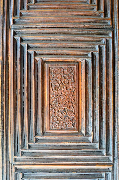 Closeup of islamic ornaments of an old an aged decorated wooden door
