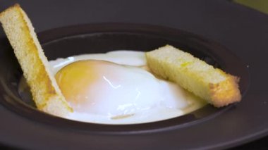 The hand of a chef who prepares a dish with a grastronomic egg, before serving his customers in the restaurant. Restaurant, food, quality, nature, gastronomy, gourmet concept.