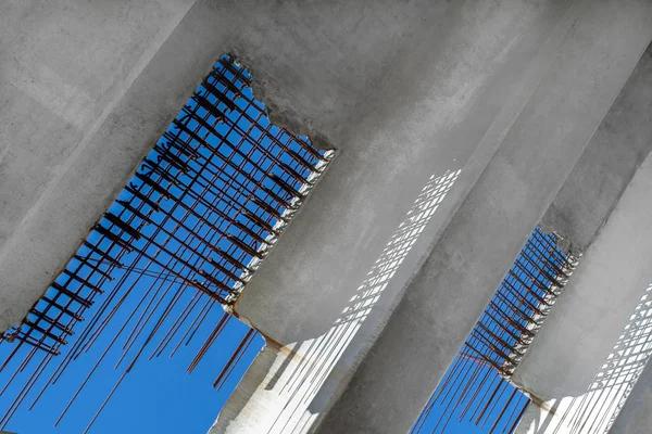 Concrete blocks with reinforcement, in the form of a reinforcing lattice, against the sky.