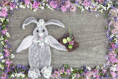 The composition of the rabbit from the leaves of the flower Stakhis and the frame of flowers Spirea and Veronica clipart