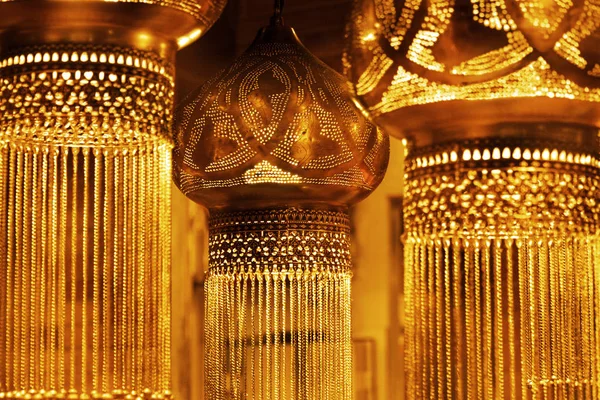 Dark vintage oriental hanging lamps in a golden glow. — Stock Photo, Image