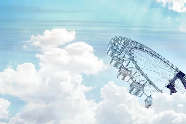 Collage. Monochrome image of a ferris wheel seen through white clouds on a turquoise sky. — Stock Photo, Image