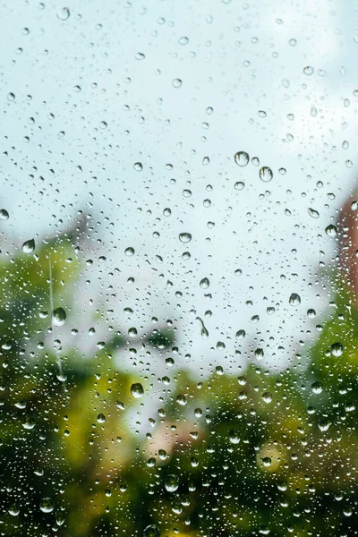 Rain drops on window pane glass surface