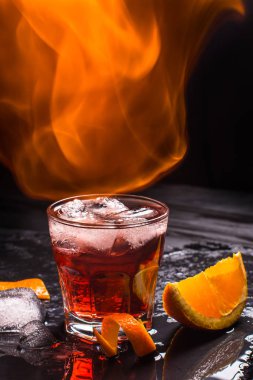 Mezcal Negroni cocktail. Smoky Italian aperitivo. Flamed orange peel. clipart