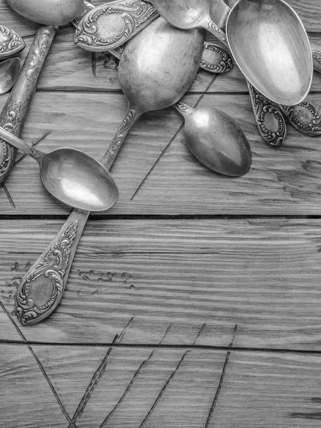 Old vintage ornamented cutlery on a wooden table