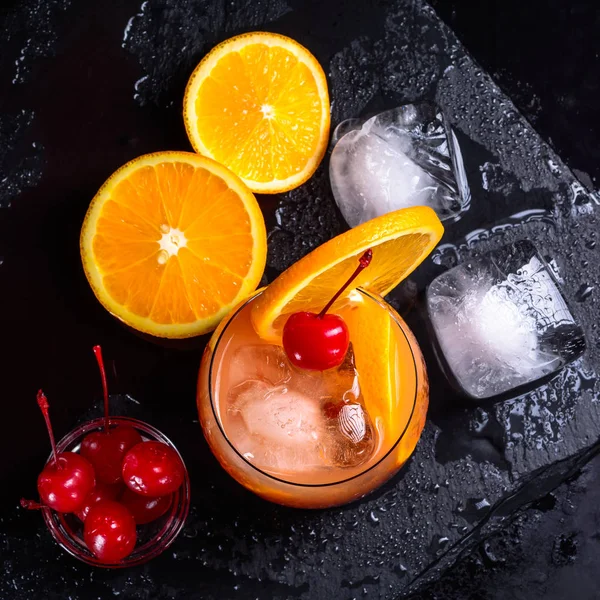 Tequila Sunrise Cocktail Orange Ice Cubes Maraschino Cherries Wet Black — Stock Photo, Image